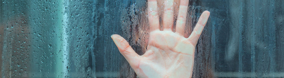 hand on wet glass under the shower