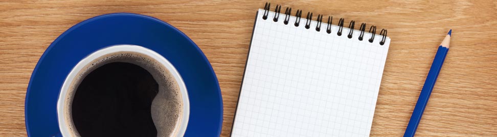 coffee cup, note pad and pencil